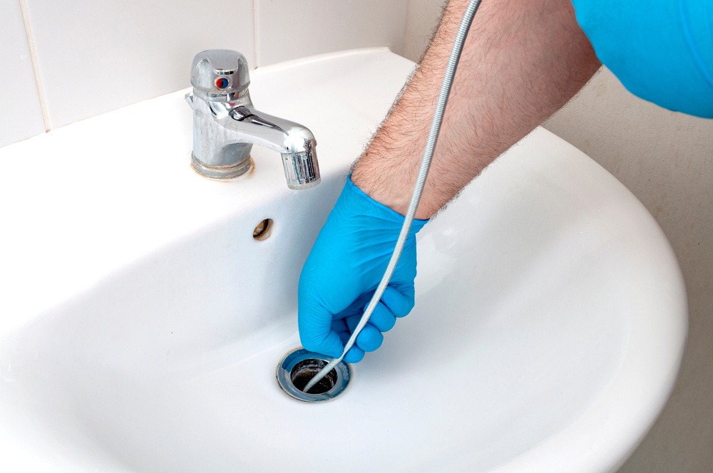 Man fixing the sink - Common Plumbing Issues and How to Solve Them